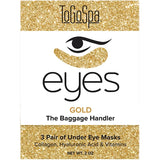 A package of eye treatments is bordered with a sparkly yellow/golden design. An eye logo is in the middle. The package reads "ToGoSpa. Eyes. Gold. The Baggage Handler. 3 Pair of Under Eye Masks. Collagen hyaluronic acid & vitamins."