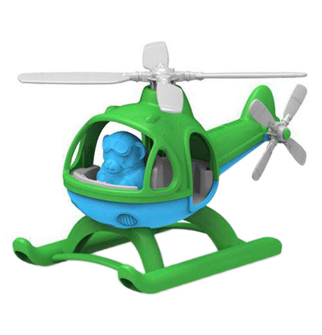 A plastic mostly green Helicopter with grey blades and a blue underbelly with a blue pilot sitting inside the cockpit