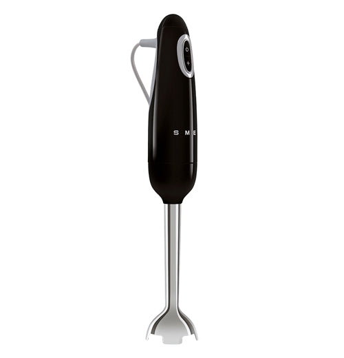  The side view of this black colored hand blender shows the on/off button and the half logo of SMEG and on the left he grey power cable, the base part is silver.
