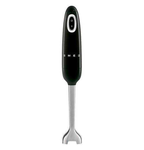 A handheld blender is stood on its' base. The body is black and the blade is stainless steel. It has an on/off button visible. The brand name "Smeg" on the body.