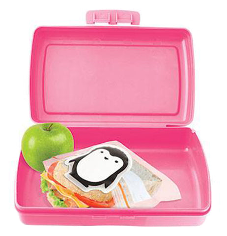 The penguin-shaped ice pack is shown inside a pink lunchbox with a sandwich and a green apple.
