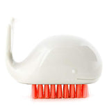 The white whale-shaped brush with red-orange bristles is shown individually.