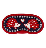 This red, white, and blue sleep mask has a picture of hedgehogs and a heart.