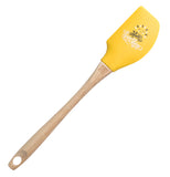 Yellow silicone and tan rubberwood handle spatula with smiling sun that says "Hello Sunshine"