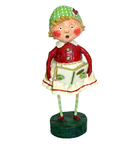 This figurine is of a girl named Holly wearing a white skirt with a red blouse and a green hat with white spots. She is seen holding a book with the title, "Carols" on its front cover.