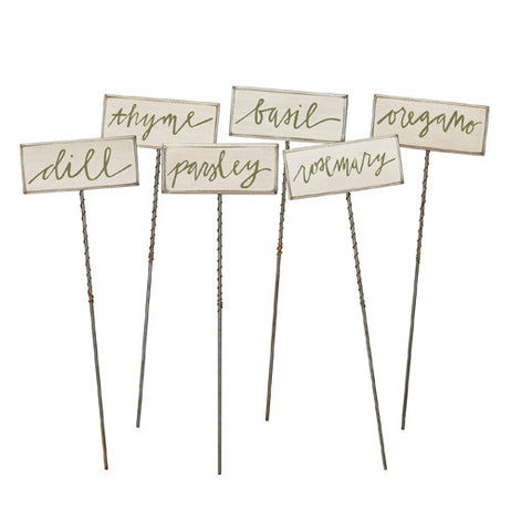 Herb picks signs on sticks with names of different herbs.