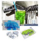 The molded shape of ice fossils from "Fossiliced" Ice Trays are in a green drink with a t-rex skeleton in the background. 