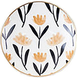 A small white dish has yellow and black plants painted on it.