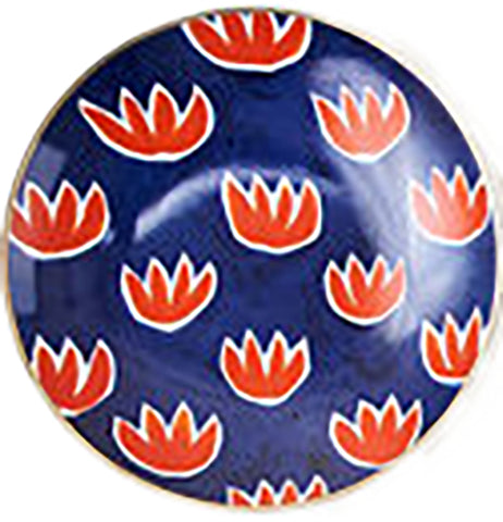A small blue dish has red flowers painted on it.