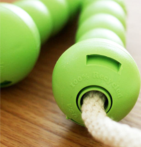 A close-up of the jump rope's green recycled handles is shown.