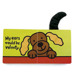 Two pages of the "If I Were a Puppy" book shows a brown puppy with white ears on a green and red background and reads, "My ears would be velety,"  along with along with a brown puppy and a black tail sticking up out of the book.