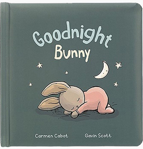 A dark green book with pastel blue and yellow text reading "Goodnight bunny Carmen Cabot Gaven Scott" on it. It also featueres a white moon and stars, and a pastel brown bunny with a pastel pink pajamas.