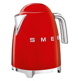 A red tea kettle has a silver handle with a silver spout, the base is also silver and the logo "Smeg" on its side