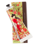 Handcreme with an image of a kabuki dancer wearing a red and white costume. Tube is on top of its box.