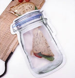 a half sandwich inside the large bag, half sticking out resting on top of a cloth on a cutting board.