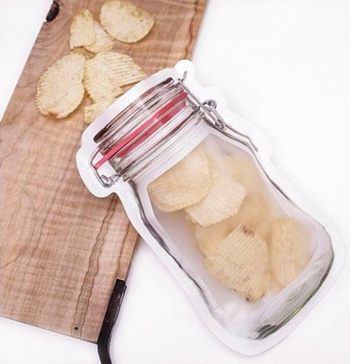 Potato chips spilling out of the bag onto a cloth on the cutting board.