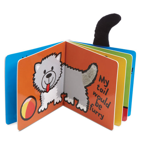 Two pages of the "If I Were a Puppy" book show a white puppy with a yellow and orange ball on an orange background and reads, "My tail would be furry.." in black lettering.