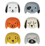 Dog head shaped pinch bowls, with their faces drawn in the center in a cartoonish style. They are white, black, gray, orange, and/or yellow.