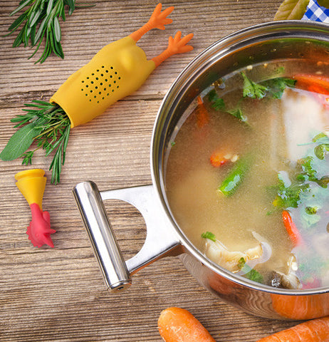 Herb infuser shaped like a chicken next to a pot of soup