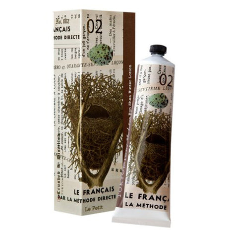 Shea butter lotion with a egg in a nest illustrated on it. The lotion is placed next to it's box.