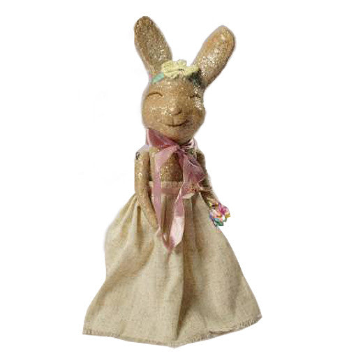 This lady rabbit is brown and has a brown dress on with a pink bow around her neck.