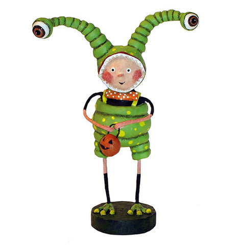 This sculpted figurine is of a child dressed as a green alien with long eye antennae. He holds an orange pail shaped like a jack-o-lantern.