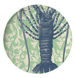 This dinner plate has a design of a dark blue lobster against a green sea grass background.