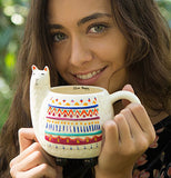 A lady drinking from her llama mug.
