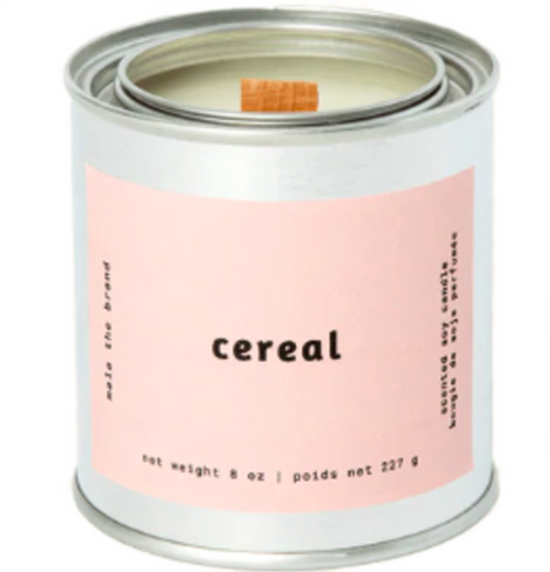 A gray tin candle-shaped can with a pastel pink label. The label says "Mala the brand--cereal--Net weight 8 oz. -- scented soy candle." There is also French text, but this alt text writer is woefully monolingual.