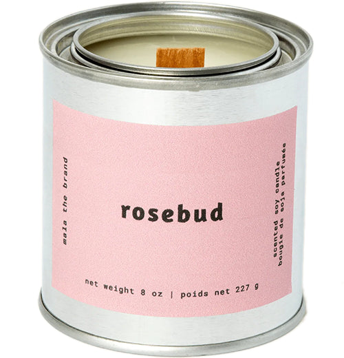 A gray tin candle-shaped can with a pastel pink label. The label says "Mala the brand--rosebud--Net weight 8 oz. -- scented soy candle." There is also French text, but this alt text writer is woefully monolingual.