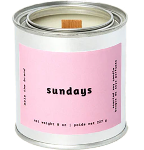 A gray tin candle-shaped can with a pastel green label. The label says "Mala the brand--bloom--Net weight 8 oz. -- scented soy candle." There is also French text, but this alt text writer is woefully monolingual.