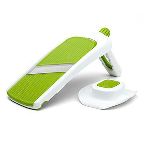 Green and white collapsible vegetable slicer. 