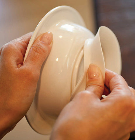 The suction base is shown being removed from the bottom of the bowl.