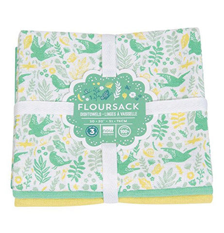 Set of 3 dish towels folded, stacked and packaged into a square. Top towel has images of green birds and flowers with yellow and light blue flowers. Middle towel is green, bottom towel is yellow.
