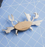 The crab-shaped Swiss army knife is shown lying on a table with all its tools open.