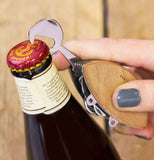The bottle opener tool on the crab-shaped Swiss army knife is shown prying the lid off a bottle.