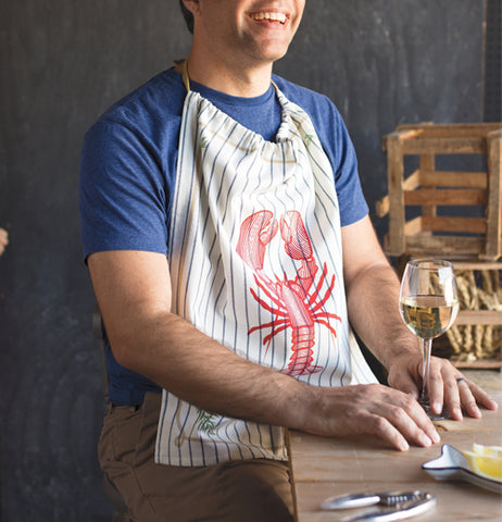 A man is seen wearing the black-striped white bib with a red lobster on its front.