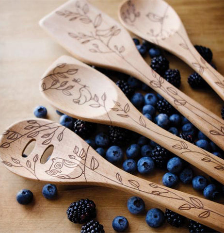 There are Four Different Slotted Spoons that have etched pictures of tree leaves on these slotted Spoons.