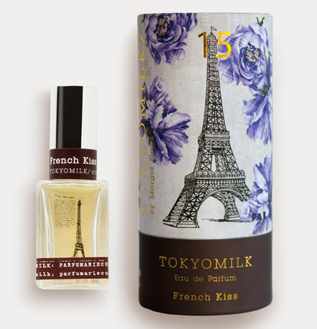 perfume is in a clear bottle with the Eiffel tower and brown edges.