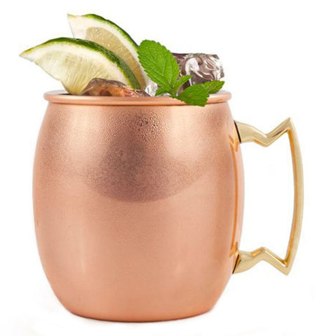  Copper mug has a handle that is a cool shape and has limes in it.