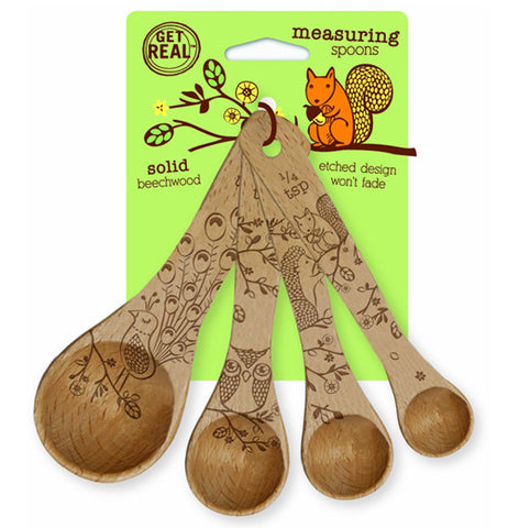 This set of measuring spoons feature their own designs of squirrels, owls, hedgehogs, and peacocks. They are shown attached to their green cardboard packaging, which has an orange image of a squirrel chewing on an acorn.