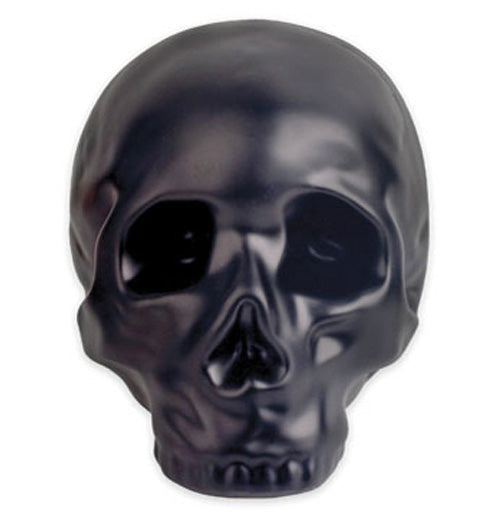 Black stoneware coin bank in the shape of a skull.