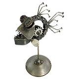 A sculpture of a piranha is made out of recycled metal. It's attached to a small circular platform with a pole. The piranha is facing the left corner.