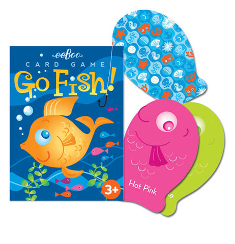 The packaging for the game with its picture of a gold fish has three fish shaped cards to the right of it one is pink, one green, and the last blue with ocean shapes on it