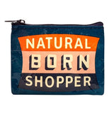Dark blue coin purse over a white background with an orange and black badge with words in white that say Natural Born Shopper.