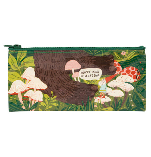 A pencil case with a gnome standing next to a pair big foot feet with mushrooms and plants all around and a word balloon that says "You&