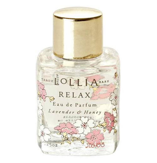 Clear perfume bottle with flowers on it and a gold lid.