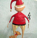 The Santa Claus figurine with the baby Comet reindeer and the small Christmas tree is shown from the back against a blue and white background.