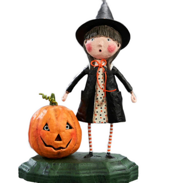 This figurine shows a young girl in a witches costume and pointed hat, standing next to a pumpkin