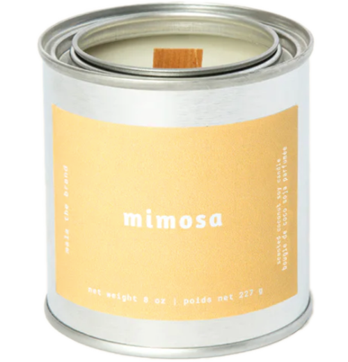 A gray tin candle-shaped can with a pastel orange label. The label says "Mala the brand--mimosa--Net weight 8 oz. -- scented soy candle." There is also French text, but this alt text writer is woefully monolingual.